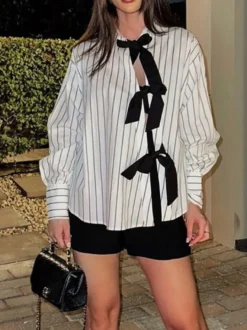 Blouse blanche pour femme col rabattu manches longues style décontracté avec nœuds.