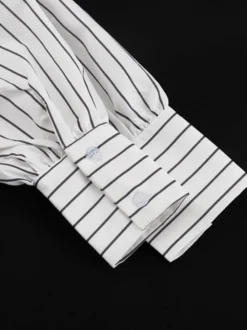 Blouse blanche pour femme col rabattu manches longues style décontracté avec nœuds.