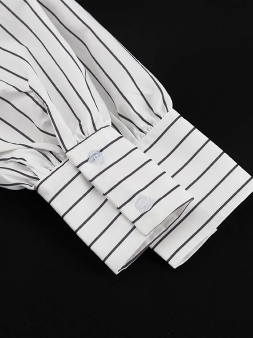 Blouse blanche pour femme col rabattu manches longues style décontracté avec nœuds.