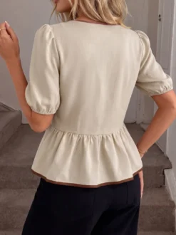 Blouse péplum à col rond et nœud contrastant manches bouffantes et manches bouffantes