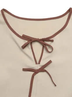 Blouse péplum à col rond et nœud contrastant manches bouffantes et manches bouffantes