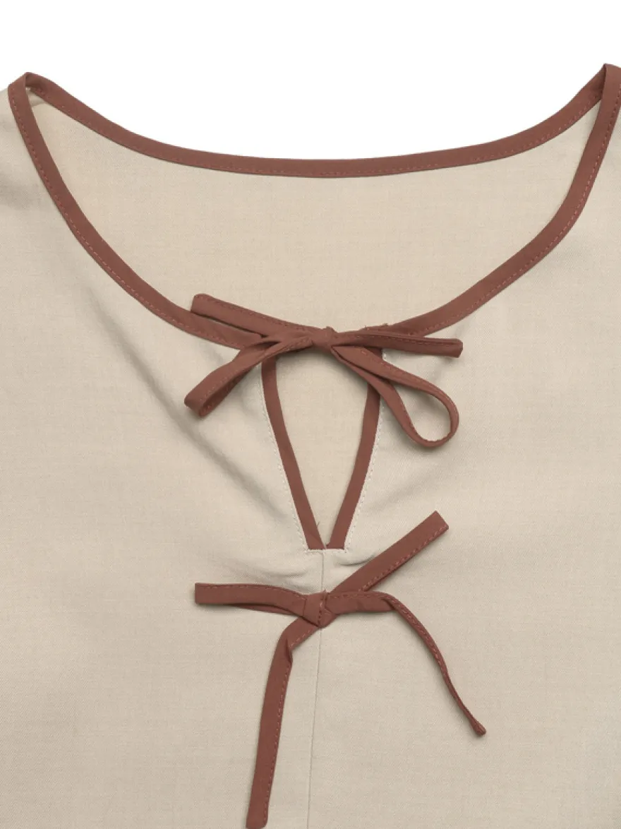Blouse péplum à col rond et nœud contrastant manches bouffantes et manches bouffantes