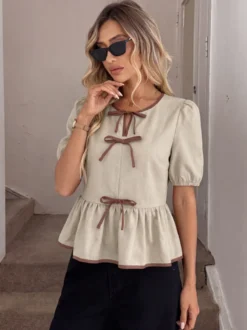 Blouse péplum à col rond et nœud contrastant manches bouffantes et manches bouffantes
