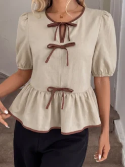 Blouse péplum à col rond et nœud contrastant manches bouffantes et manches bouffantes