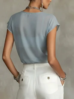 Blouse transparente à manches courtes et imprimé floral style aquarelle vintage en mousseline ample.