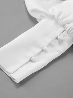 Chemisier péplum blanc élégant pour femme - Col V dos nu manches lanternes coupe ajustée - Idéal pour le printemps et le soir (2026)