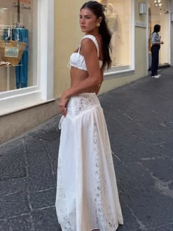 Ensemble deux pièces blanc décontracté avec jupe sans manches sculptante et découpes idéal pour la plage.