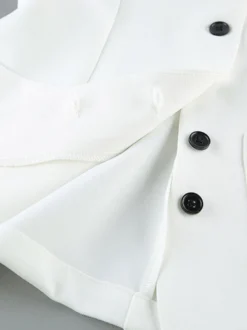 Ensemble deux pièces : boutons blancs col rond chic jupe sans manches.