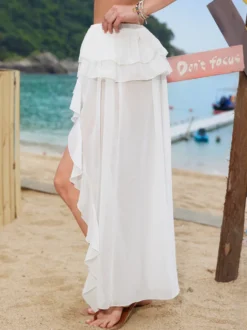 Jupe longue maxi à volants asymétriques pour femme en mousseline superposée fendue de façon irrégulière fluide idéale pour la plage.