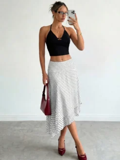 Jupe midi blanche à petits pois taille haute ourlet asymétrique à volants irréguliers en mousseline fluide.