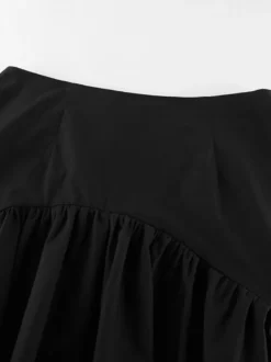 Jupe noire asymétrique mi-longue à volants et taille haute