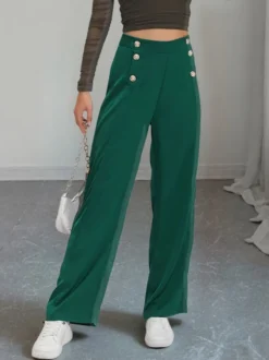Pantalon de costume taille haute à double boutonnage et jambes larges coupe drapée.