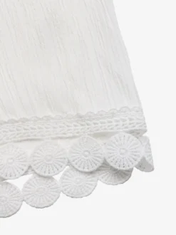 Pantalon large à ourlet en dentelle blanche et cordon de serrage coupe ample et décontractée idéal pour l'été.