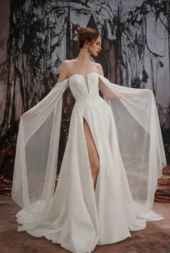 Robe de mariée gothique noire en dentelle coupe trapèze manches longues taille naturelle à volants et traîne