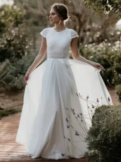 Robe de mariée simple en mousseline de soie col bijou manches courtes découpes courtes 30 cm