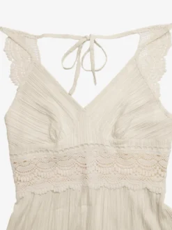 Robe longue fluide d'été pour femme couleur crème avec bretelles spaghetti et taille en dentelle blanche col en V.