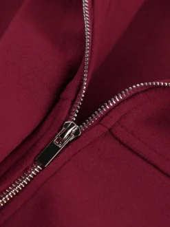 Veste bomber courte rouge bordeaux à col minimaliste fermeture éclair intégrale et poignets élastiques