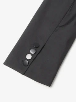 Veste de tailleur cintrée à corset en maille ajourée et dos transparent avec baleines à la taille.